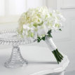 white roses and white dendrobium orchid blossom bouquet